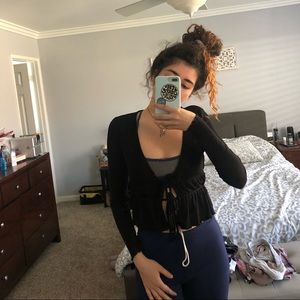 Black long sleeve ties twice in front